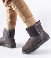 Person wearing ankle-high Arvessa Big Star low-heel snow boots in eco leather with brown pants, showcasing durable winter footwear.