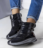 Orymira insulated platform snow boots with opalescent leather and plush fur lining, featuring slip-on design and thick sole for warmth.