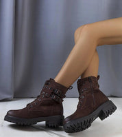 Woman wearing Ardevra insulated ankle boots with suede-look texture and bold strap detailing for autumn-winter fashion.