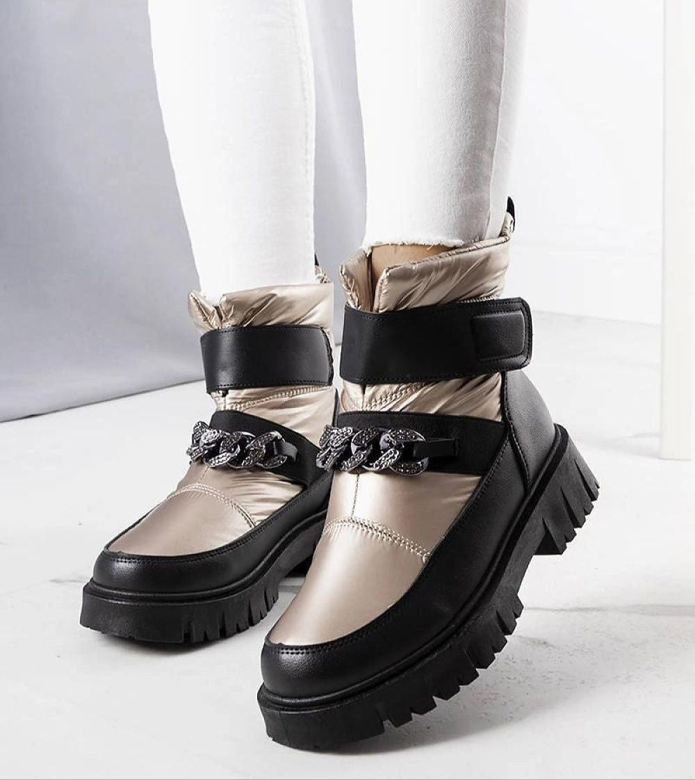 Solvara winter chain snow boots with metallic chain, waterproof panels, eco leather, thick sole, and Velcro fastening, styled on feet.