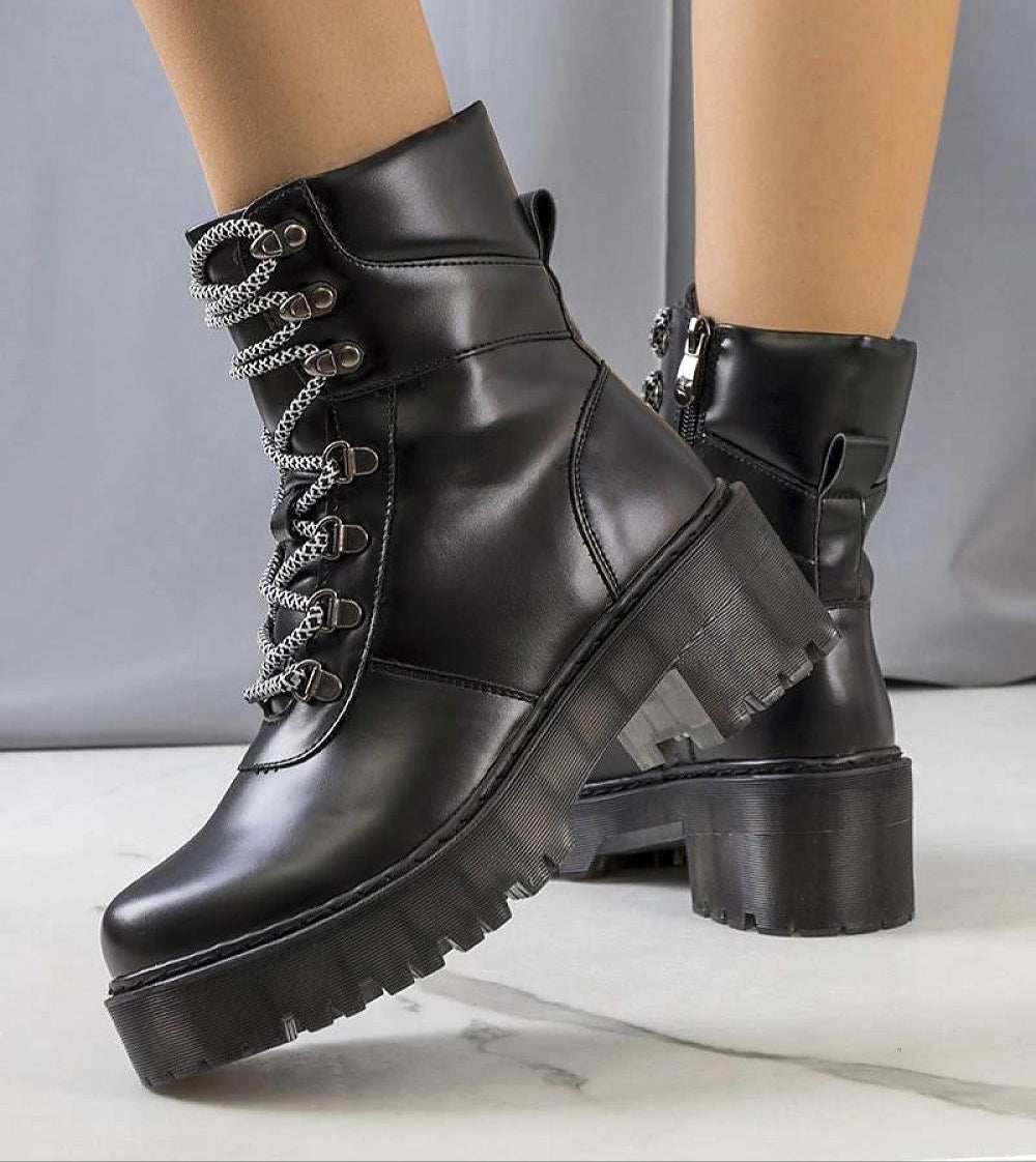 Black Eravine high-sole winter boots with decorative lacing, showcasing thick platform soles for bold style and cozy lining for warmth.