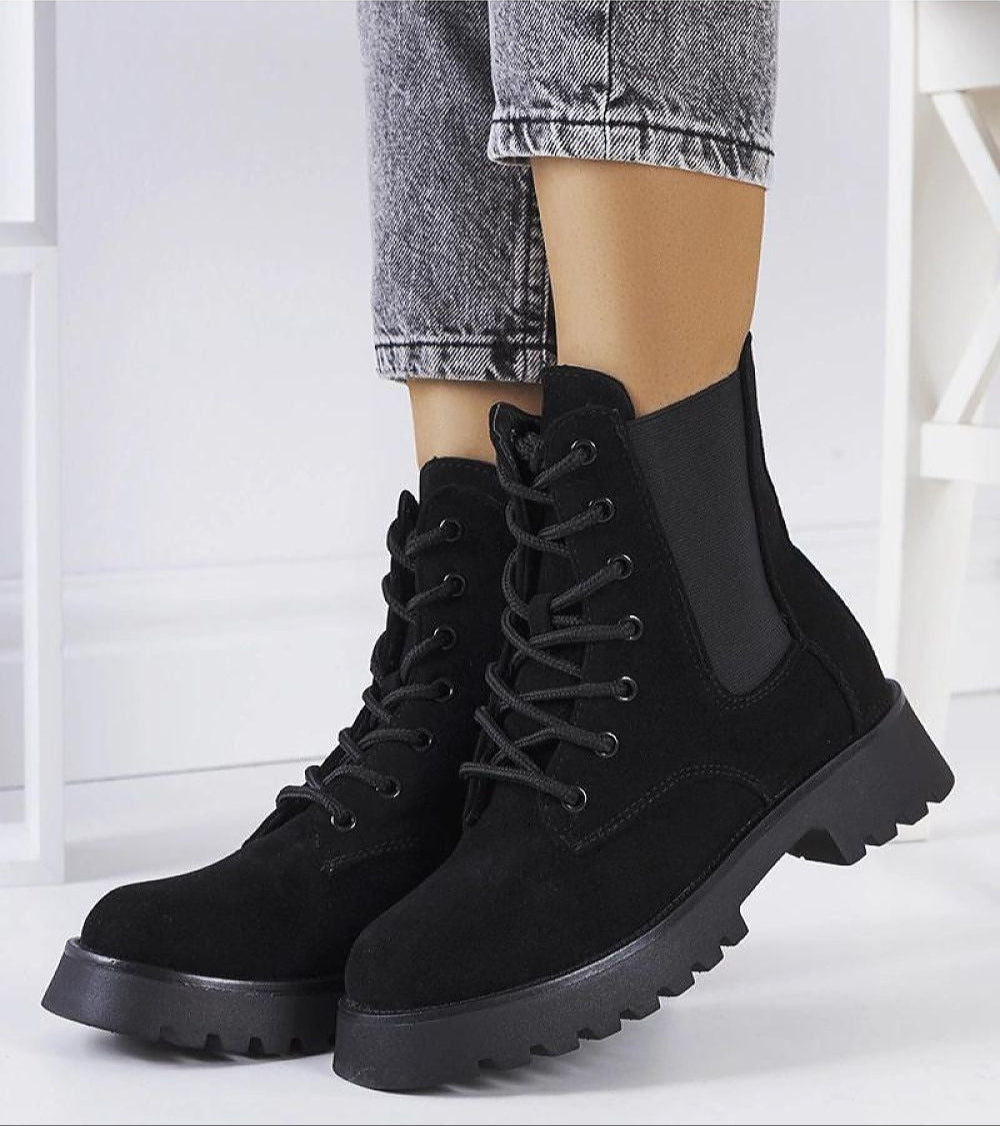 Everleigh Ridge Winter Boots with chunky sole, side zipper, and eco-leather upper, styled with ankle-high jeans, ideal for cold days.