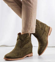 Evelari wedge ankle boots in olive green, featuring a slip-on design, sculpted silhouette, and elevated sole for transitional seasons.