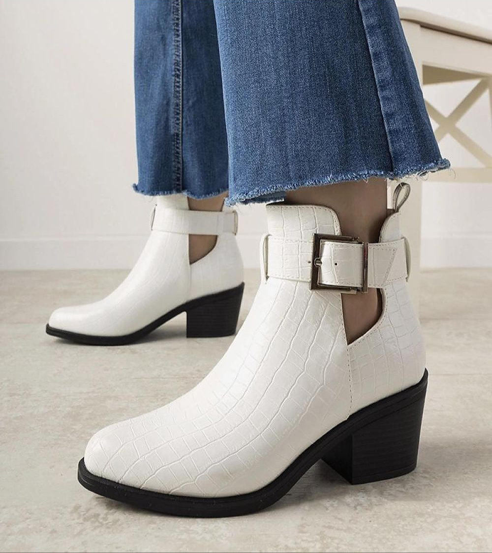 Crocodile-effect eco leather ankle boots with side cut-outs, adjustable strap, and 6 cm block heel, contrasted with denim jeans.