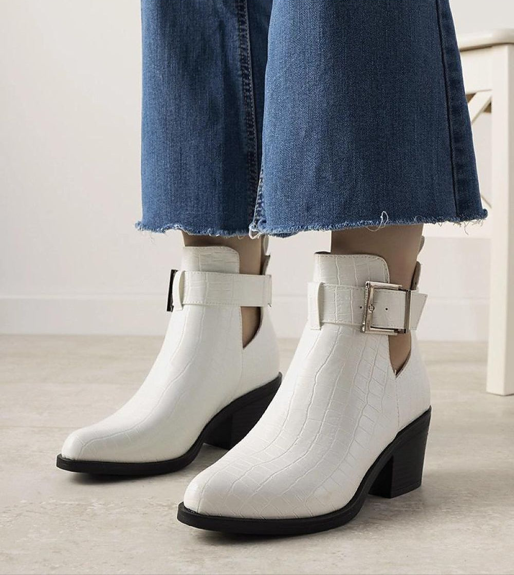 White Alvarine cut-out ankle boots with block heel and ankle strap, crafted in crocodile-effect eco leather, paired with blue jeans.