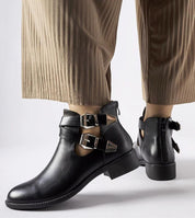 Dravelle cut-out ankle boots with dual buckle straps, metal buckles, and a rounded toe in eco leather, offering a stylish, edgy look.