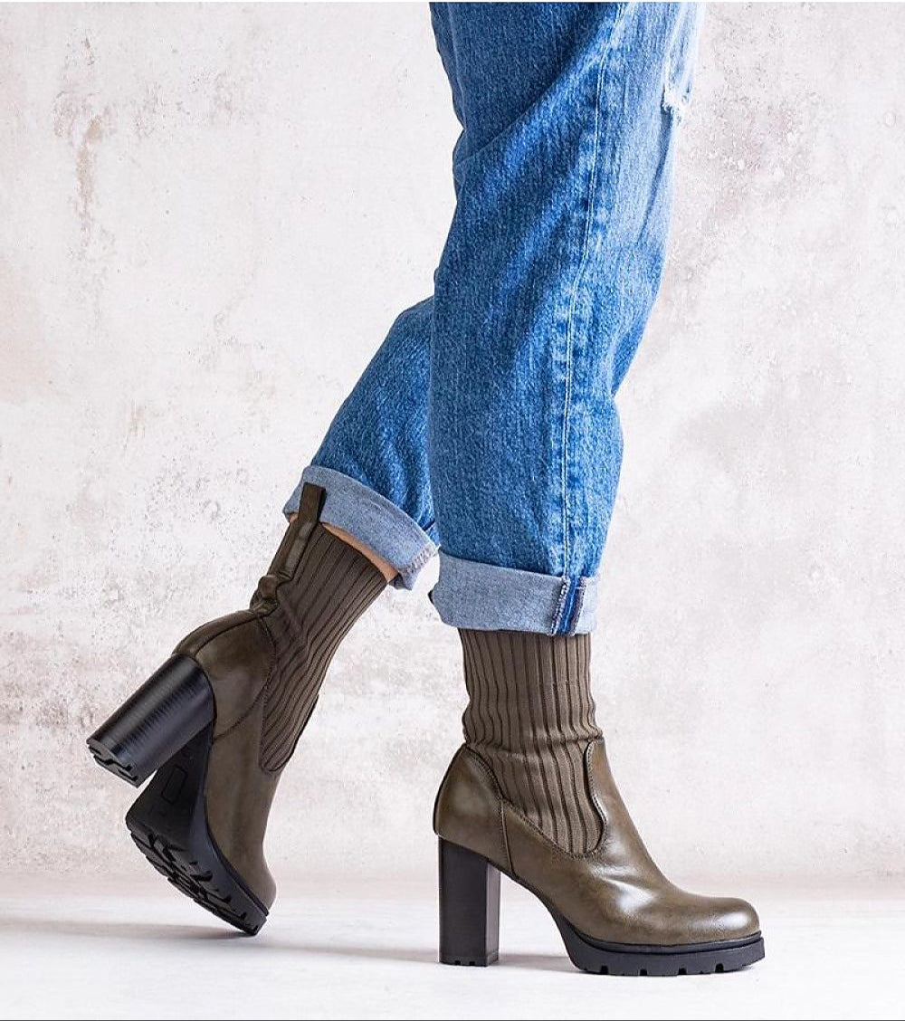 Person wearing Nuvarelle Stiletto Ankle Boots with jeans, showcasing olive green leather and block heels.