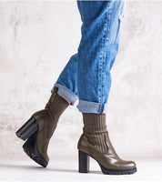 Person wearing Nuvarelle Stiletto Ankle Boots with jeans, showcasing olive green leather and block heels.