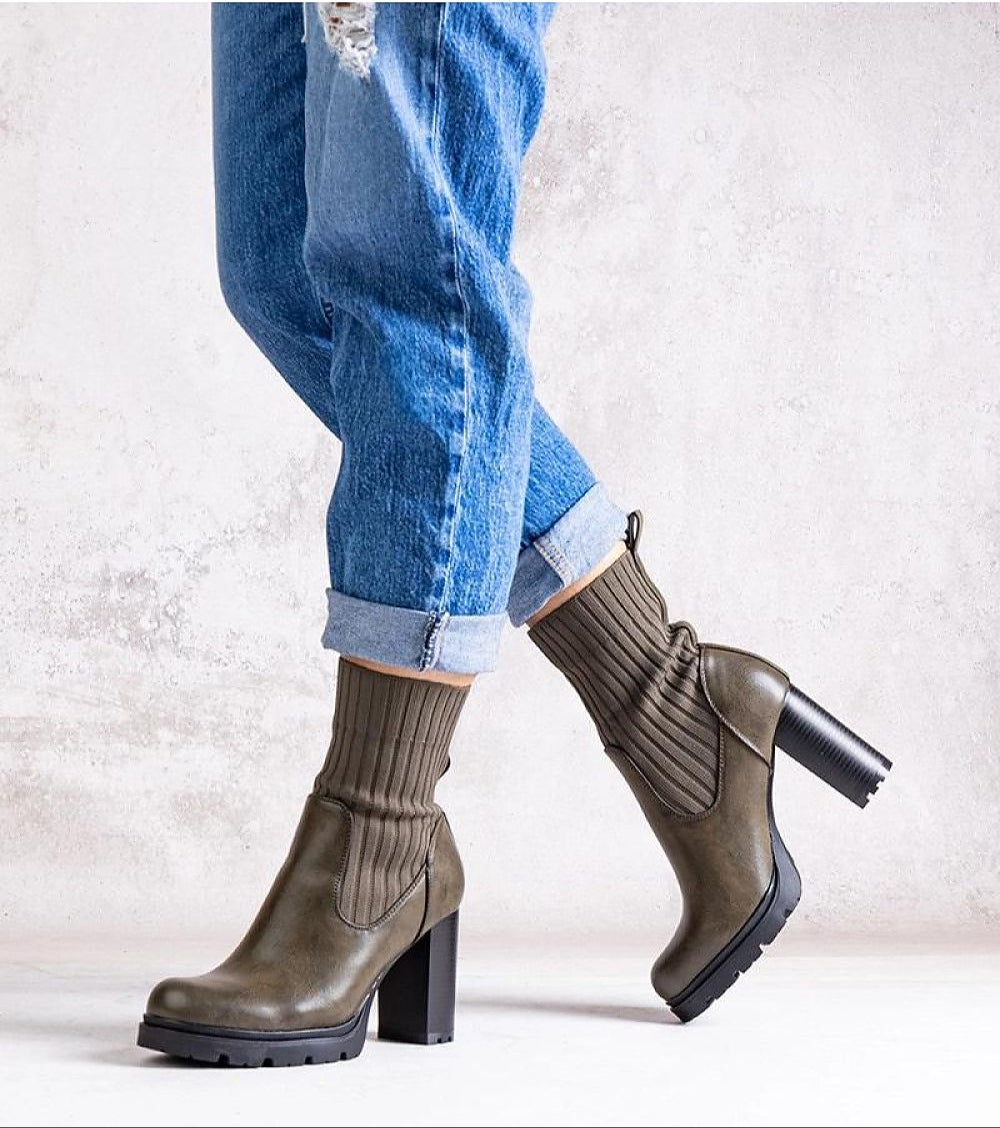 Model wearing Nuvarelle Stiletto Ankle Boots with 9 cm heel and almond-shaped toe, styled with jeans, showcasing elegant autumn footwear.
