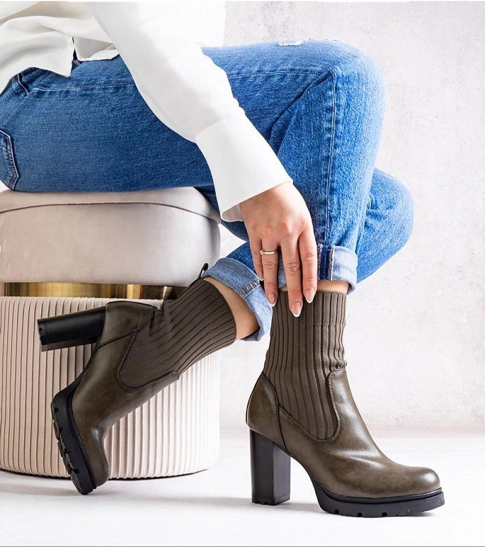 Woman wearing Nuvarelle stiletto ankle boots with jeans, showcasing elegance and functionality for autumn styling.