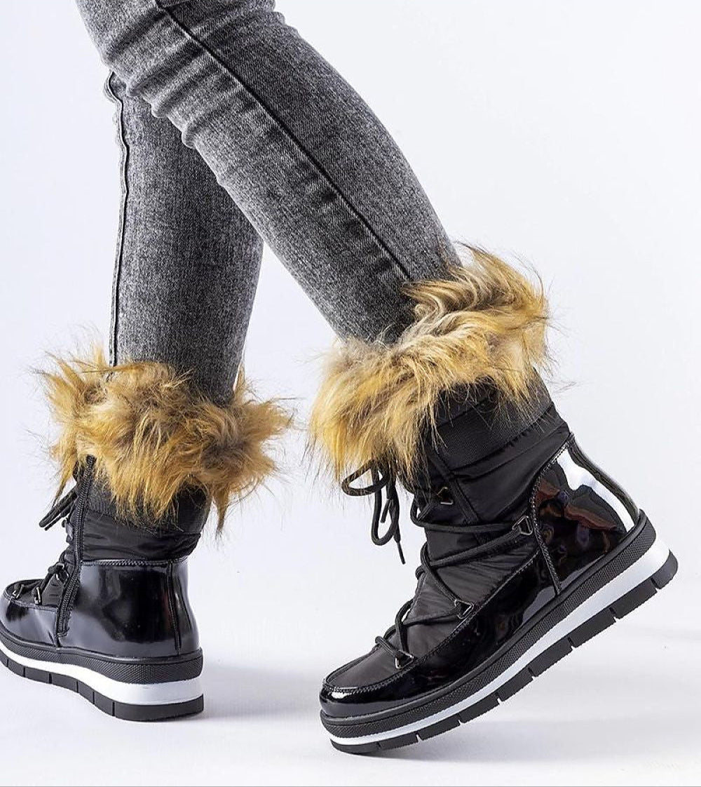 Woman wearing Furelle Gloss Winter Boots with faux fur trim and glossy black finish, showcasing knee-high style and platform soles.