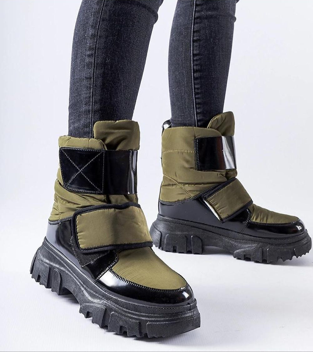 Velgora Winter Grip Boots with tall insulated shaft and Velcro strap, offering stability and warmth for harsh winter conditions.