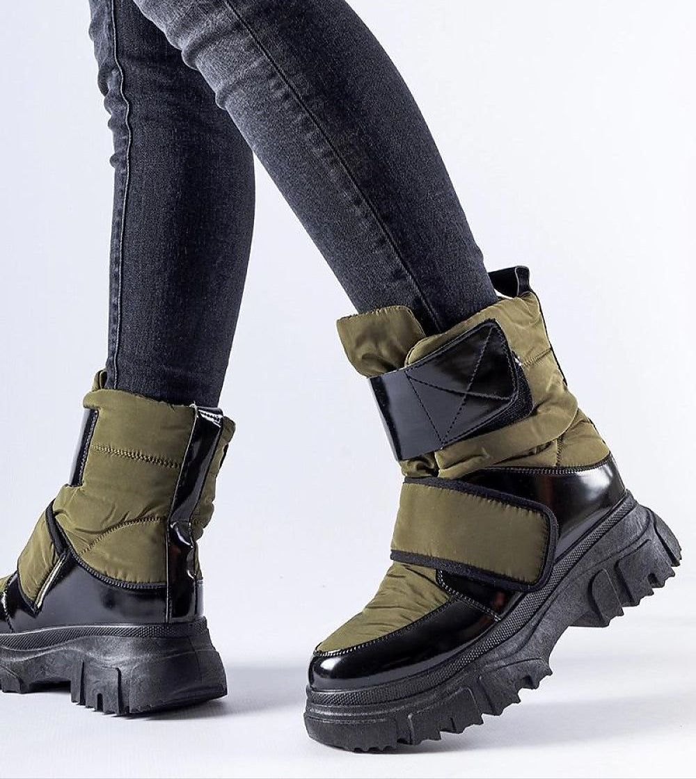 Velgora Winter Grip Boots with Velcro strap and rubber sole for stability and warmth, worn with jeans, ideal for icy conditions.