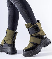 Velgora Winter Grip Boots with Velcro strap and rubber sole for stability and warmth, worn with jeans, ideal for icy conditions.