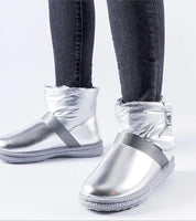 Woman wearing Brivona Glossy Velcro Snow Boots with rounded toes, 3 cm platform, silver finish, and Velcro closure for winter comfort.
