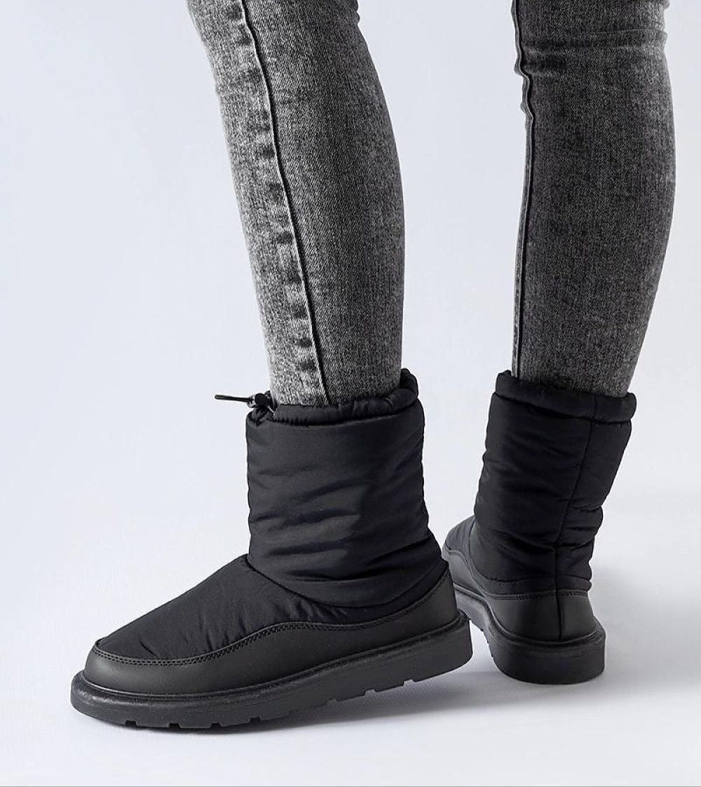 Sylverra Slip-On Winter Snow Boots with waterproof rubber sole and sleek design, perfect for icy conditions.