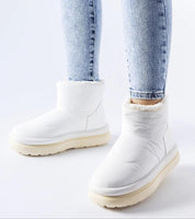 Person wearing Kirella Insulated Platform Snow Boots in white, showcasing cozy design and sleek slip-on style for winter fashion.