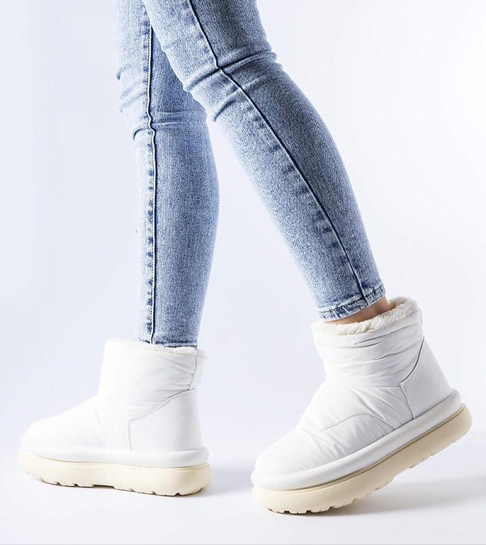 Person wearing Kirella Insulated Platform Snow Boots with jeans, showcasing winter style and comfort.