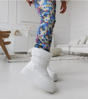 Person wearing Olviera Slip-On Platform Snow Boots with colorful leggings indoors, showcasing winter style and comfort.