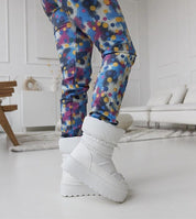 Person wearing Olviera slip-on platform snow boots inside stylish room, showcasing bold design and 5 cm platform.