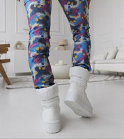 Person wearing white Olviera Slip-On Platform Snow Boots with colorful leggings, showcasing durable rubber sole and 5 cm platform.