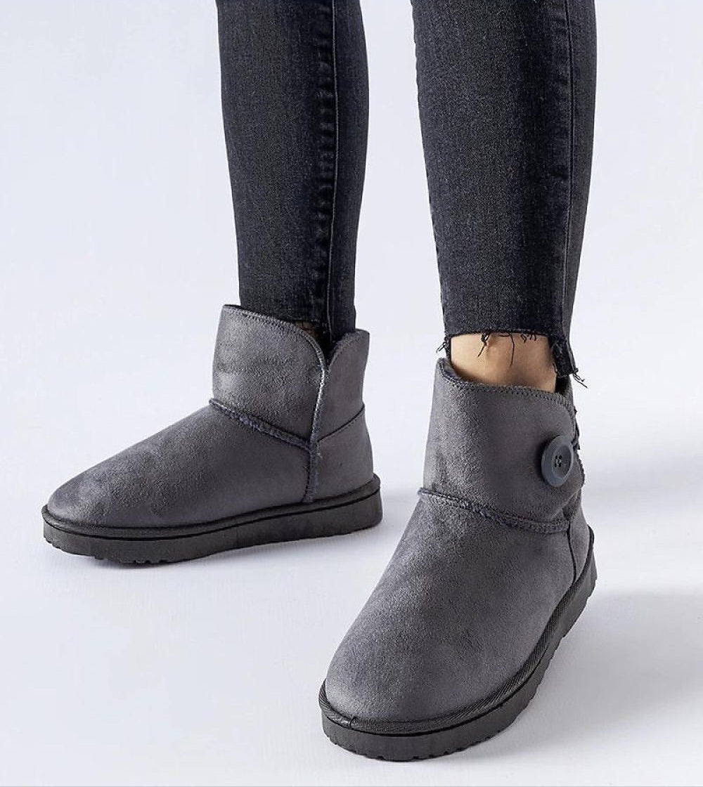 Ankle-high gray Narevik Slip-On Winter Snow Boots with button detail, worn with black jeans on a white background.