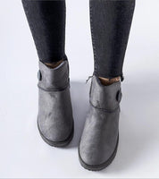 Person wearing Narevik Slip-On Winter Snow Boots with jeans, showcasing the grey ankle-high design and durable water-resistant fabric.