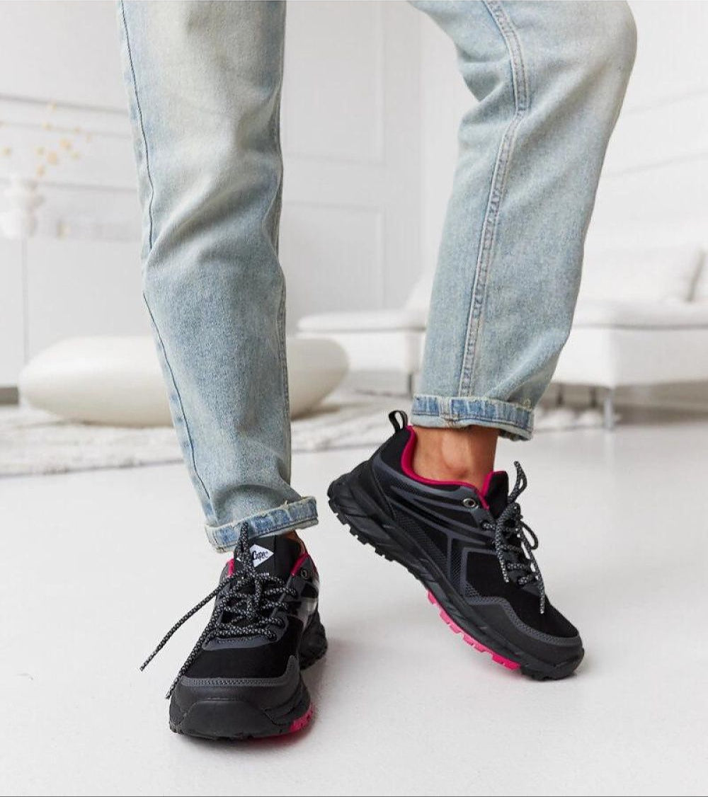 Person wearing Norvina Insulated Winter Sneakers with eco leather, stepping forward on a white floor indoors.