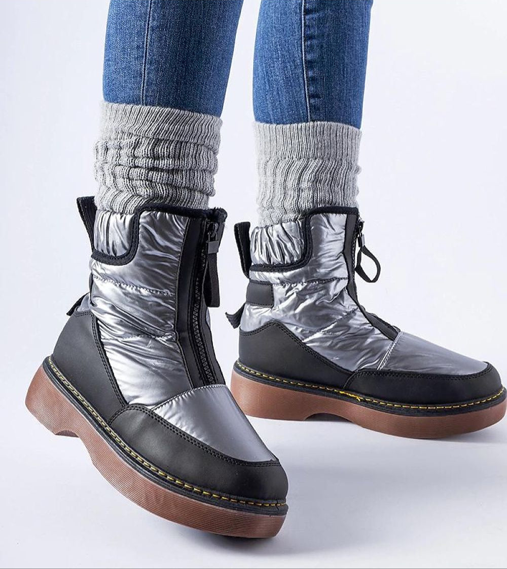 Woman wearing Zandara Waterproof Winter Boots with side zipper and flat heel, perfect for snowy urban and outdoor walks.