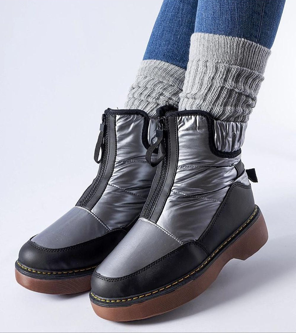 Person wearing Zandara Waterproof Winter Boots in grey and black with side zipper, showing traction sole and warm knit socks.