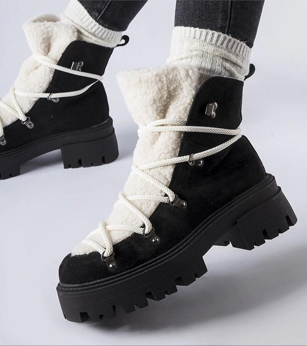 Perivana Lace-Up Winter Baggers in black with eco leather, decorative tongue, and durable rubber sole for warmth and traction.