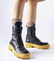 Vereliane Winter Boots with rubberized exterior, high ankle support, and flat yellow soles offering style and warmth in cold weather.