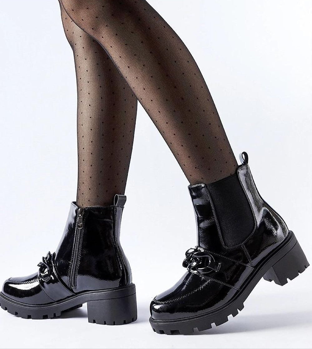 Velandra Glossy Buckle Boots in black patent-effect eco leather with metal buckle and side zipper on model's feet.