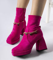 Bright pink square-toe heel boots with chain pendant detail, showcasing bold 9 cm heel and eco leather finish for winter elegance.