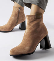 Tan suede ankle boots with a side zipper and chunky heel, perfect for a stylish and comfortable winter look.