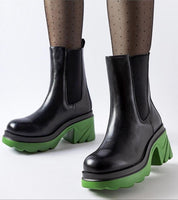 Black high-heel winter boots with green soles, featuring an elevated design and slip-on style.