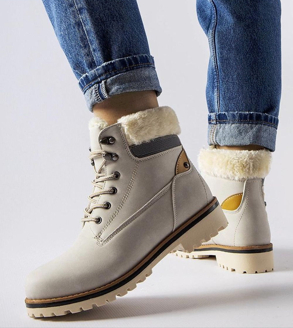 Person wearing Montalbino Insulated Winter Trappers in light color, featuring lace-up front and warm lining, ideal for cold weather.