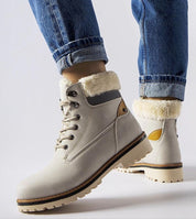 Person wearing Montalbino Insulated Winter Trappers in light color, featuring lace-up front and warm lining, ideal for cold weather.
