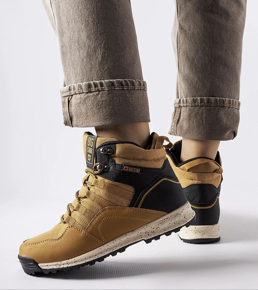 Person wearing Big Star insulated winter sneakers with durable textile, lace-up front, high-top design, and flat rubber sole.