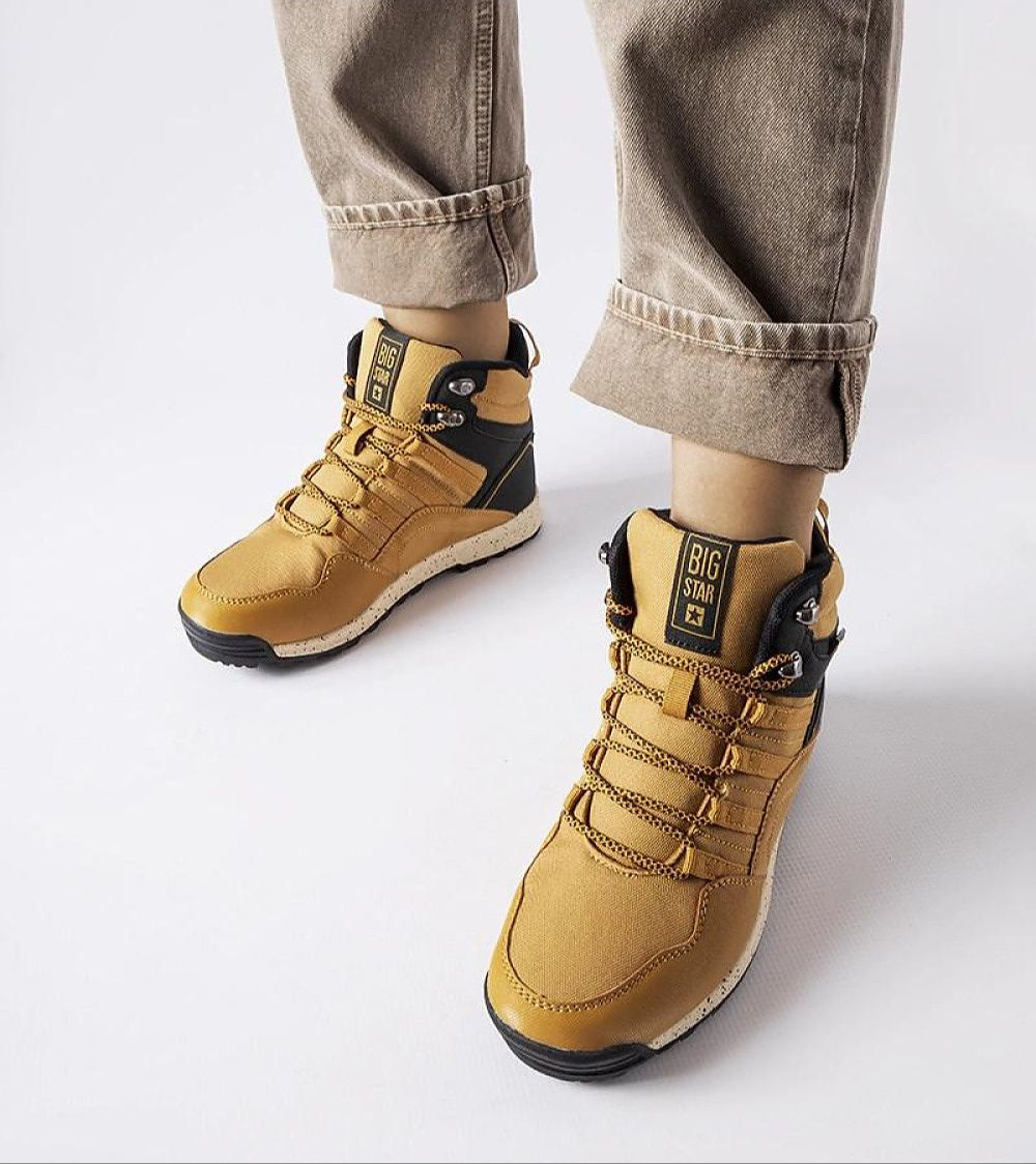 Person wearing Big Star insulated winter sneakers with high-top design, flat rubber sole, and lace-up front, perfect for cold weather.