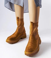 Solmare Eco-Suede Slip-On Boots with brown upper, medium heel, and rubber sole, showcasing stitch detail for autumn fashion.