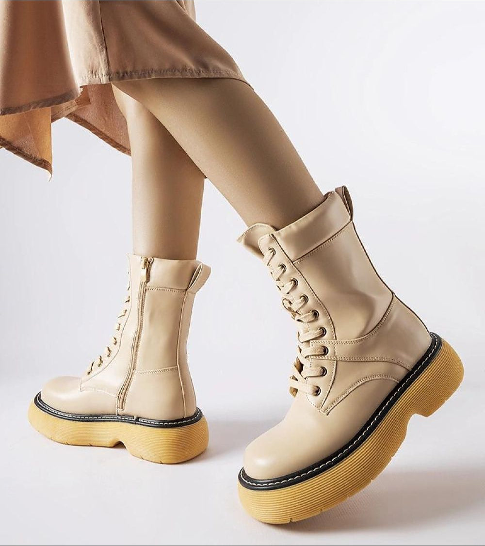 Beige Davi Platform Bagger Boots with yellow soles and side zippers, offering a stylish and cozy option for winter wear.