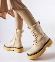 Beige Davi Platform Bagger Boots with yellow soles and side zippers, offering a stylish and cozy option for winter wear.