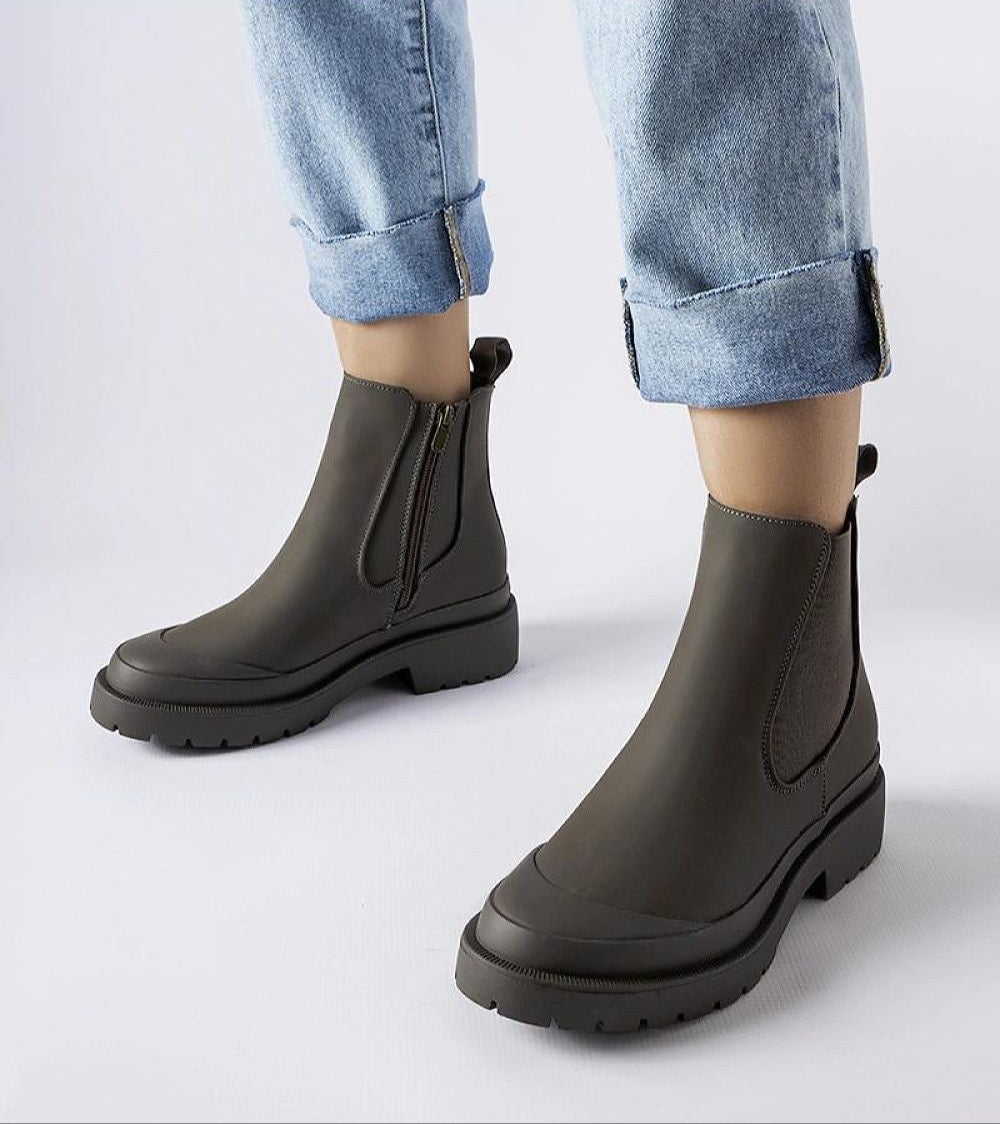 Varenta Weatherproof Platform Boots with zipper, shown worn with jeans, featuring a sleek waterproof design and sturdy platform sole.