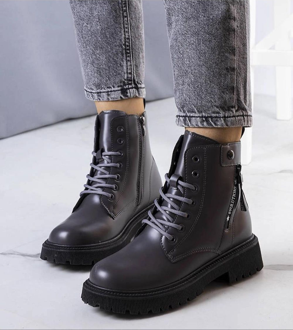 Gray fur-lined winter trapper boots with eco leather, shown with jeans. Stylish and warm for snowy adventures.