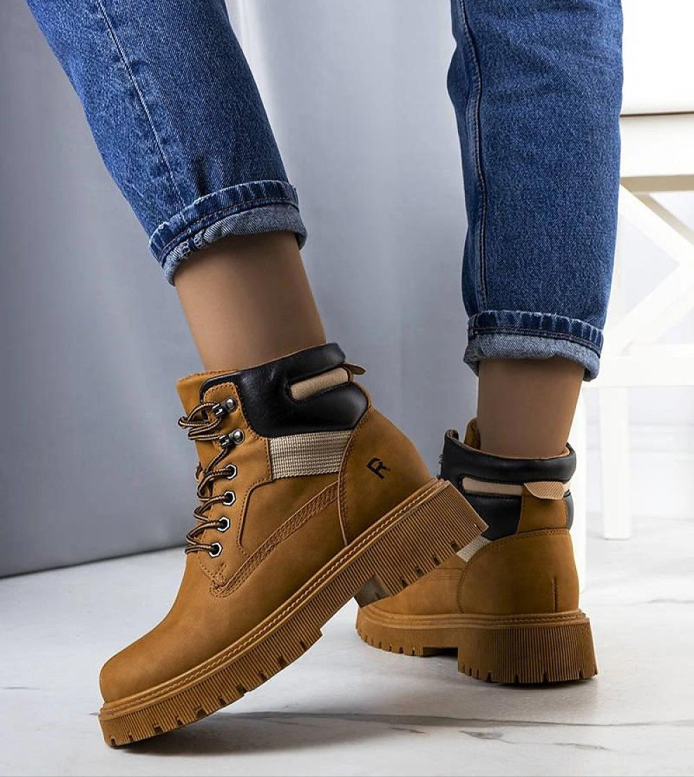 Brown leather trapper boots with fur lining, perfect for winter adventures. Features a flat rubber sole and lace-up front for secure fit.