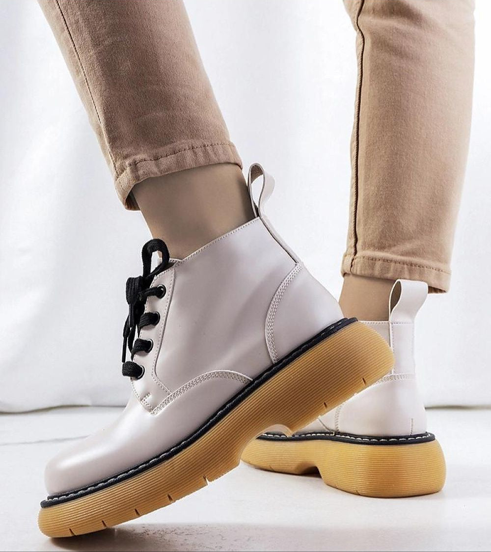White matte lace-up boots with yellow soles, perfect for autumn. Eco leather, modern design. Ideal for stylish seasonal outfits.