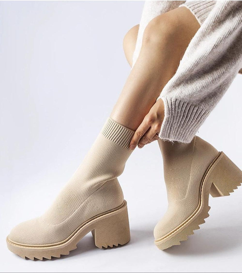 Woman wearing Merissia Beige Sock Ankle Boots with 7 cm heel, showcasing elegant style and comfort in a minimalist design.