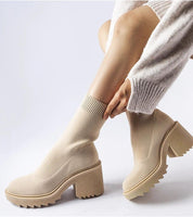 Woman wearing Merissia Beige Sock Ankle Boots with 7 cm heel, showcasing elegant style and comfort in a minimalist design.