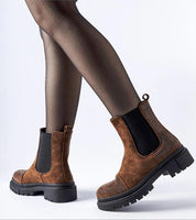 Brivola Brown Suede Ankle Boots with Zircons and black elastic panel, featuring a chunky sole, worn with black stockings.